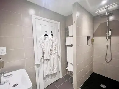 a bathroom with a shower and a sink at Mode Cottage in Lytham St Annes