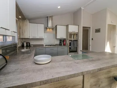 a large kitchen with a large wooden counter top at The Three Bears Lodge, Coniston Drive 11 in Carnforth