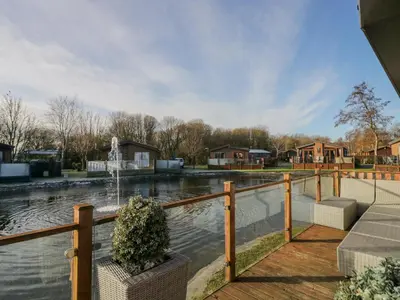 a fountain in the middle of a pond at The Three Bears Lodge, Coniston Drive 11 in Carnforth