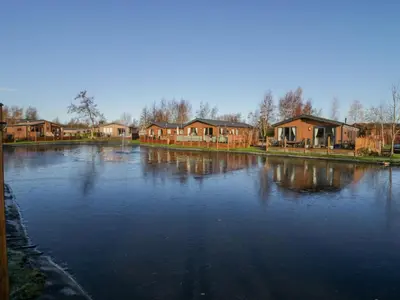 a large river with houses in the background at The Three Bears Lodge, Coniston Drive 11 in Carnforth