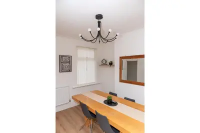 a dining room with a table and chairs at Anfield Haven for 6 in Liverpool