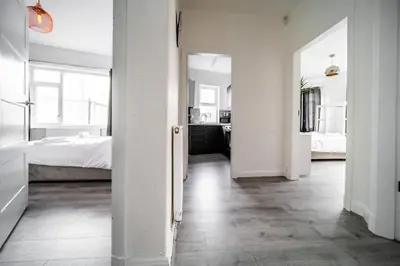 a white room with a bedroom and a bed at Spacious Apartment With A Terrace Style Rooftop in Cleveleys