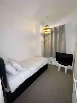 a bedroom with a bed and a flat screen tv at Parking Walk to Tower Winter Gardens and Main Attractions in Blackpool