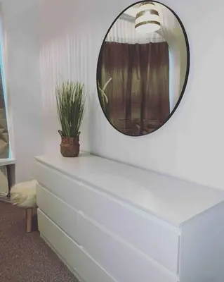 a mirror above a dresser with a plant on it at Parking Walk to Tower Winter Gardens and Main Attractions in Blackpool
