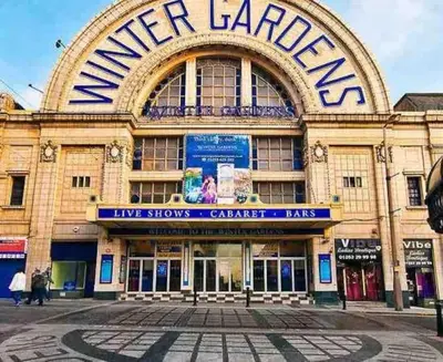 a large building with a sign on the front of it at Parking Walk to Tower Winter Gardens and Main Attractions in Blackpool