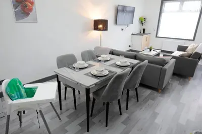 a living room with a table and chairs and a couch at Dixon House, Sleeps 6, Free Parking, Long or Short Stays - by NMB Property in Horwich