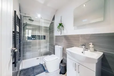 a bathroom with a toilet and a sink and a shower at Large 6-Bed house, Free Parking & Motorway Access in Ashton in Makerfield