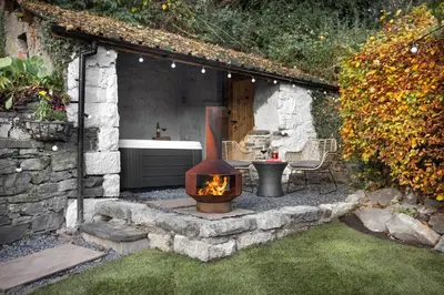 a backyard with a fire pit in the yard at Mead Cottage a Tranquil Retreat in the Heart of the Lake District - Ridgestone in Lindale