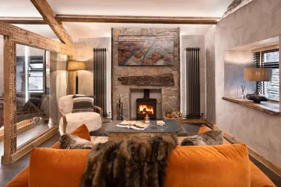 a living room with a couch and a fireplace at Mead Cottage a Tranquil Retreat in the Heart of the Lake District - Ridgestone in Lindale