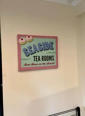 a sign on a wall that reads stable tea rooms next to a sign on at Lorton Villa with a Log Burner in Saint Helens
