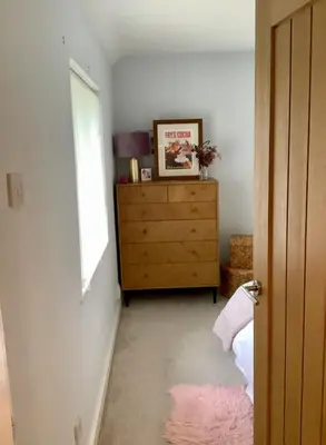 a bedroom with a dresser and a window at Lorton Villa with a Log Burner in Saint Helens