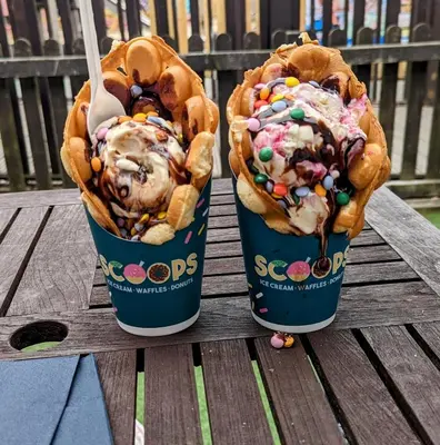 two ice creaminis sitting on top of a wooden table at Jenny and Jamie's holiday home on the edge in Morecambe