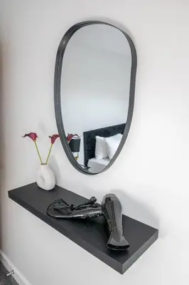 a mirror on a black shelf with a sink at 1-Bed apartment with Sofa Bed right by Liverpool ONE & Concert Square in Liverpool