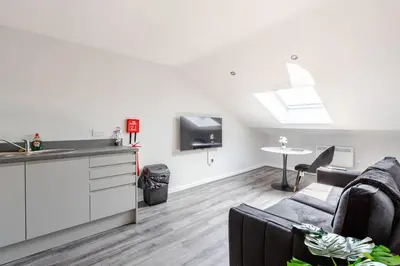 a kitchen and living room with a couch and a tv at 1-Bed apartment with Sofa Bed right by Liverpool ONE & Concert Square in Liverpool