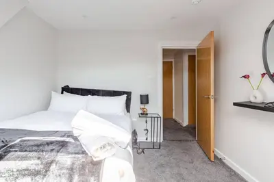 a bedroom with a white bed and a mirror at 1-Bed apartment with Sofa Bed right by Liverpool ONE & Concert Square in Liverpool