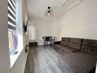 a living room with a couch and a table at JMC's Place in Blackpool