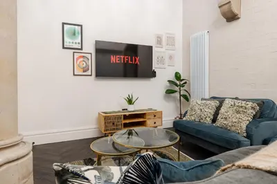a living room with a couch and a tv at The Spire! Historic Features Rare 1800s Church in Waterloo