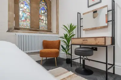 a room with a desk and a chair and a window at The Spire! Historic Features Rare 1800s Church in Waterloo
