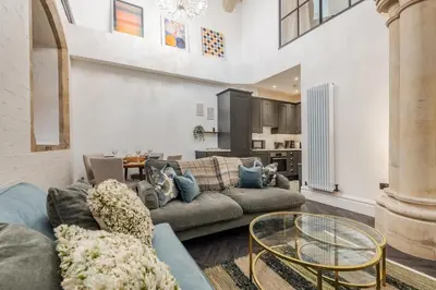 a living room with a couch and a glass table at The Spire! Historic Features Rare 1800s Church in Waterloo
