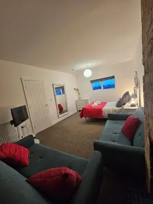 a living room with a couch and a bed at Market Quarter, town centre, free parking and wifi in Southport