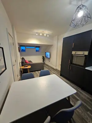 a living room with a white table and chairs at Market Quarter, town centre, free parking and wifi in Southport