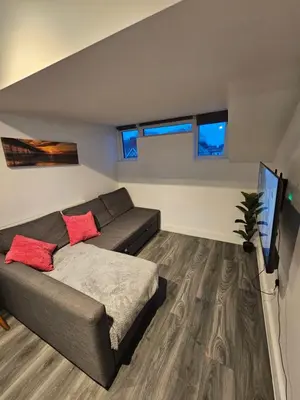 a living room with a couch and a flat screen tv at Market Quarter, town centre, free parking and wifi in Southport