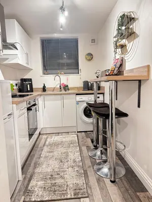 a kitchen with white cabinets and a sink and a dishwasher at City Link Apartments Perfect Stay for Concert Goers, Football Fans and Contractors, Closer to Liverpool City Centre, Everton, Liverpool Grounds in Liverpool