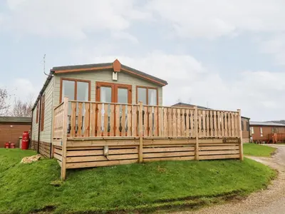 a small house with a wooden fence at 6 Sherwood in Carnforth