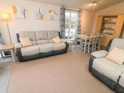 a living room with a couch and a table at 6 Sherwood in Carnforth