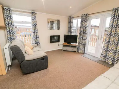 a living room with a couch and a television at 6 Sherwood in Carnforth