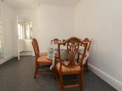 a dining room with a table and two chairs at 21 Eaves Street in Blackpool