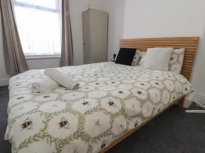 a bedroom with a bed with a bedspread with bees on it at 21 Eaves Street in Blackpool