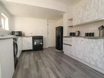 a kitchen with a washer and dryer at 21 Eaves Street in Blackpool