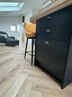 a black dresser with a chair in a living room at The Retreat in Eccleston