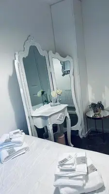 a white bedroom with a sink and a mirror at House - Sleeps 6 Hot-tub & Free Parking in Skelmersdale