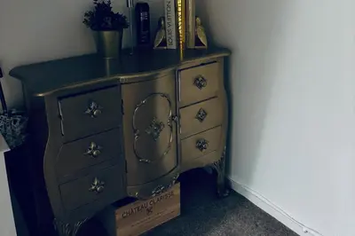 an old wooden dresser with a black counter top at House - Sleeps 6 Hot-tub & Free Parking in Skelmersdale