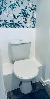 a white toilet in a bathroom with floral wallpaper at House - Sleeps 6 Hot-tub & Free Parking in Skelmersdale