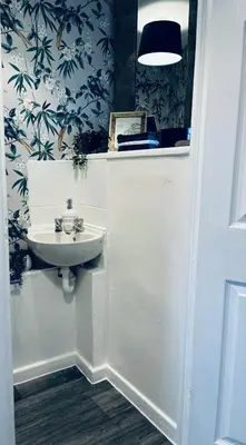a bathroom with a sink and blue and white wallpaper at House - Sleeps 6 Hot-tub & Free Parking in Skelmersdale