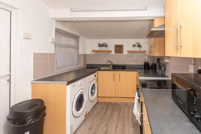 a kitchen with a washer and dryer in it at Modern 3 bed, sleeps 8 in Saint Helens