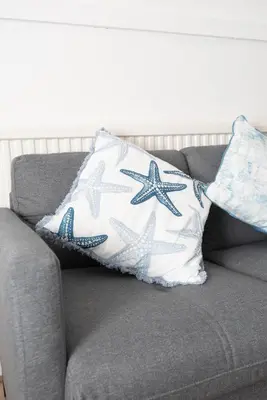 a gray couch with two pillows on it at Modern 3 bed, sleeps 8 in Saint Helens