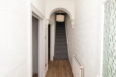a hallway with a stairway with a stair case at Modern 3 bed, sleeps 8 in Saint Helens