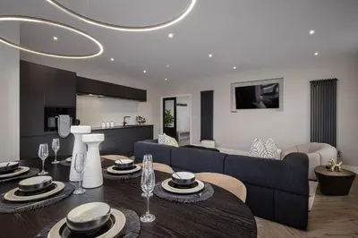 a living room with a couch and a table at The Shoreline Collection by STAMP in Blackpool