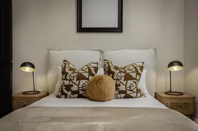 a bed with two lamps and a stuffed animal on it at The Shoreline Collection by STAMP in Blackpool