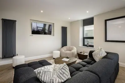 a living room with a couch and a table at The Shoreline Collection by STAMP in Blackpool