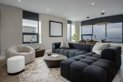 a living room with a couch and a chair at The Shoreline Collection by STAMP in Blackpool
