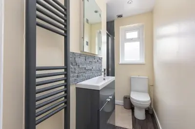 a bathroom with a toilet and a sink at Beachcliffe Holiday Apartments in Blackpool