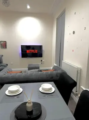 a living room with a table and a couch at City Centre 2 Bed 2 Bath Apartment in Preston