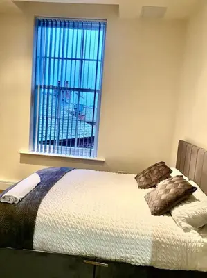 a bedroom with a bed and a window with a view at City Centre 2 Bed 2 Bath Apartment in Preston