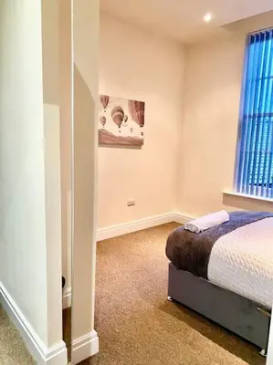 a bedroom with a bed and a window at Luxury City Apartment 2 Bedroom Suite in Preston