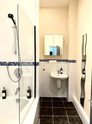 a white bathroom with a sink and a shower at Luxury City Apartment 2 Bedroom Suite in Preston